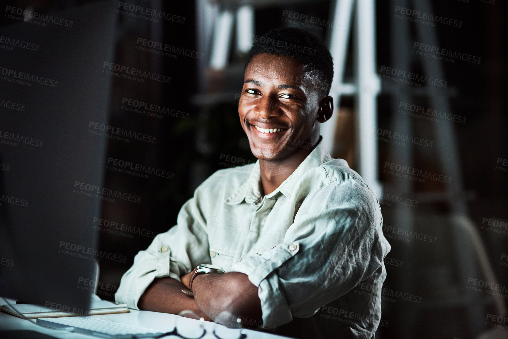 Buy stock photo Night, man and smile in office, portrait and video editing with software, planning and freelancer. Dark, entrepreneur and computer for content creation, black person and creative for social media