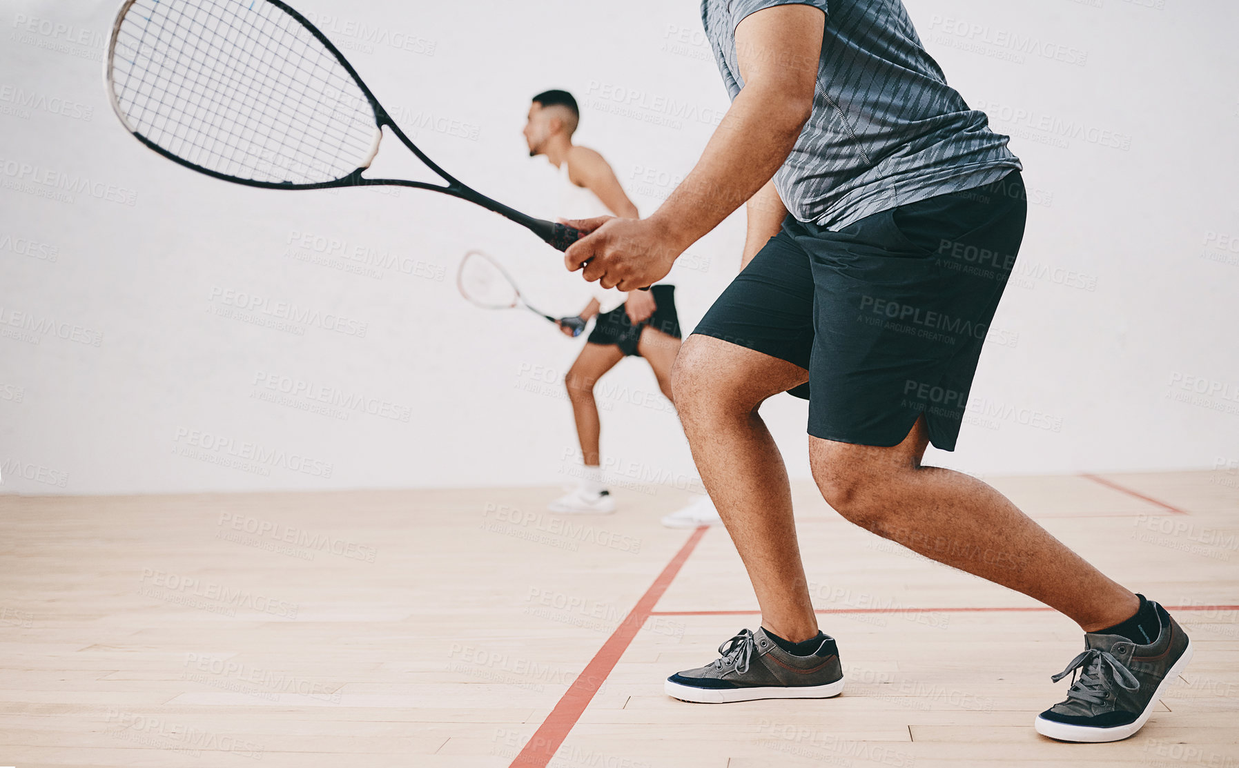 Buy stock photo Shot of two young men playing a game of squash