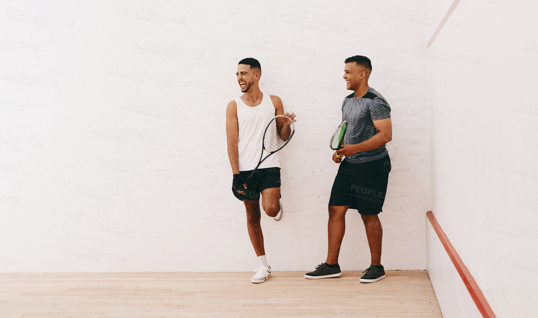 Buy stock photo Shot of two young men standing together on a squash court