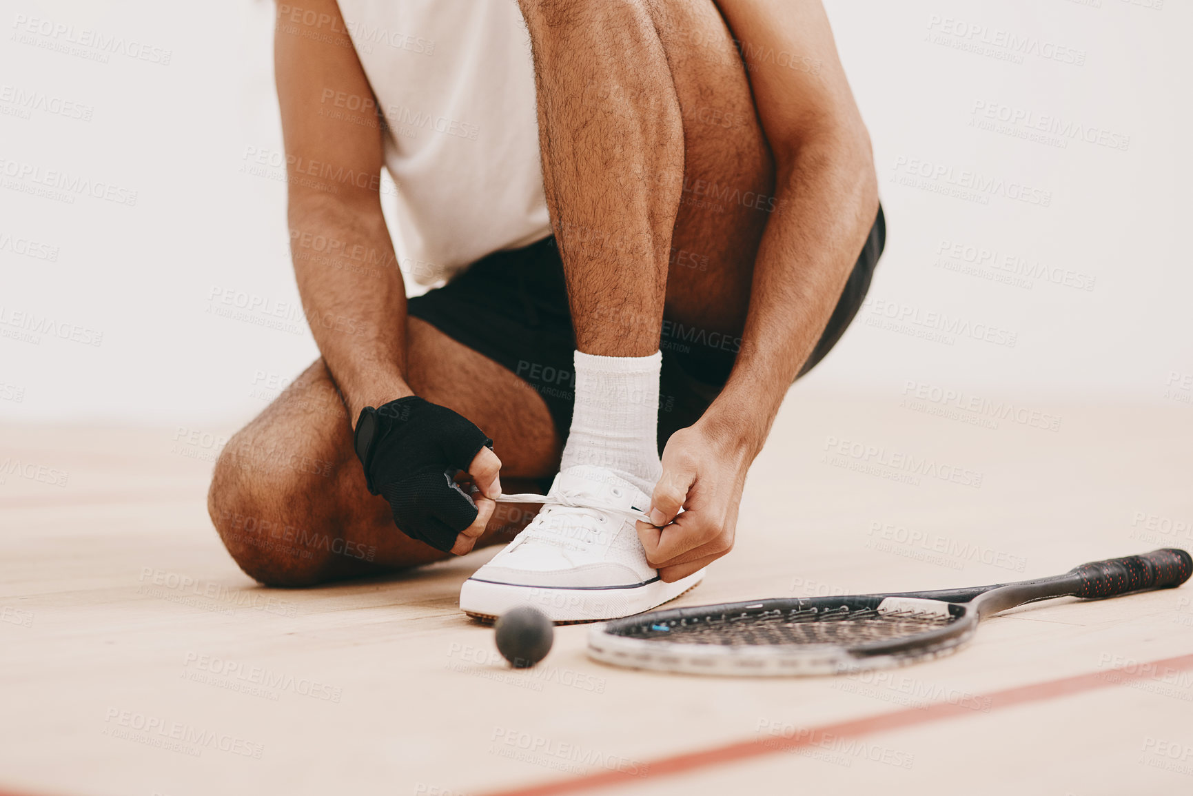 Buy stock photo Squash, man and hands tying shoes on court for sport, ready and start of match. Athlete, person and preparation in fitness center for racquetball, challenge and competition in tournament at club