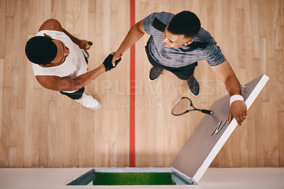Buy stock photo High angle shot of two young men shaking hands at a squash court