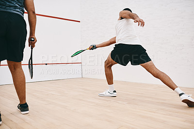Buy stock photo Shot of two young men playing a game of squash
