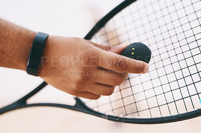 Buy stock photo Cropped shot of a man serving a ball with a racket during a game of squash