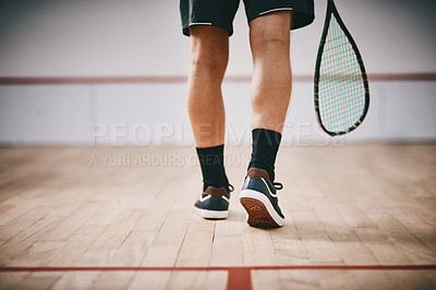 Buy stock photo Cropped shot of an unrecognisable man playing a game of squash