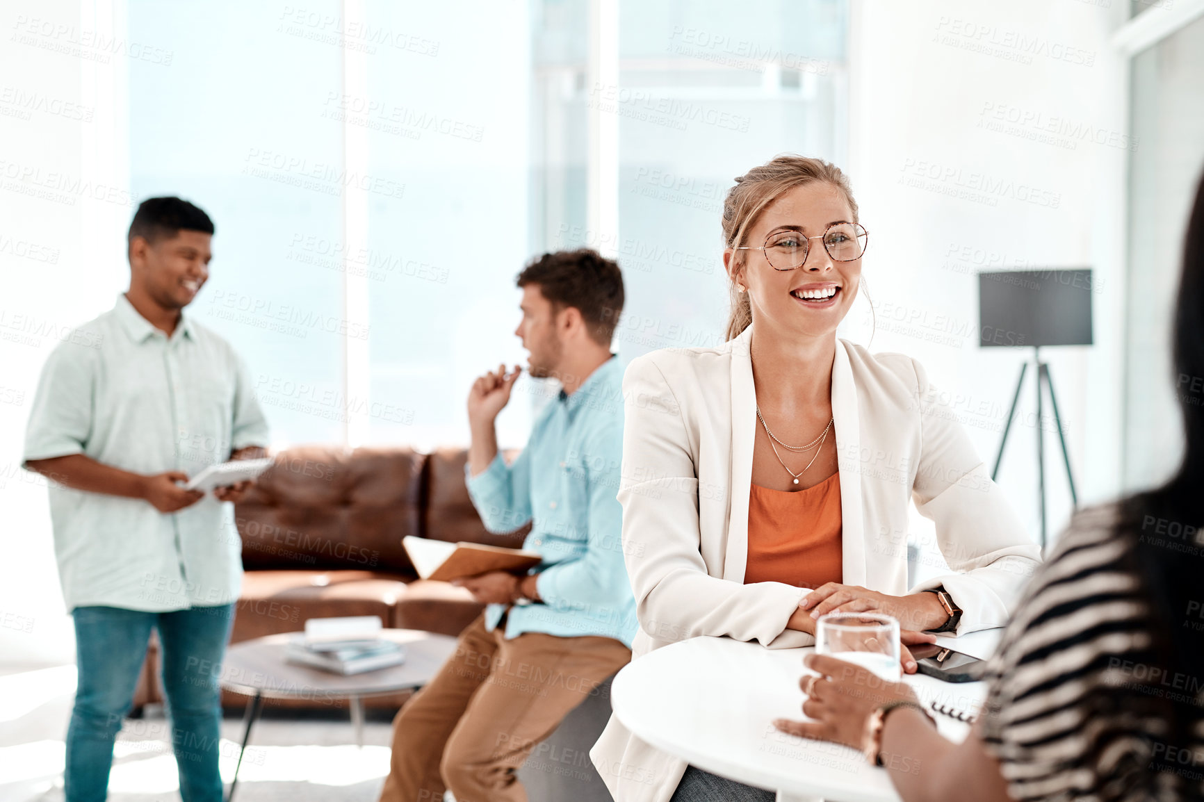 Buy stock photo Cropped shot of a group of young businesspeople socializing in their office