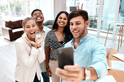 Buy stock photo Cropped shot of a group of young business colleagues taking selfies in their office