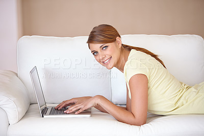 Buy stock photo Woman, portrait and typing on laptop at sofa to update blog post, social media or digital subscription for remote work. Happy freelancer on computer for online shopping, email or relax in living room