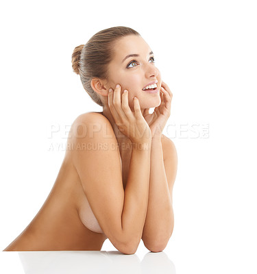 Buy stock photo Cropped shot of a gorgeous young woman looking away with a smile while posing nude against a white background