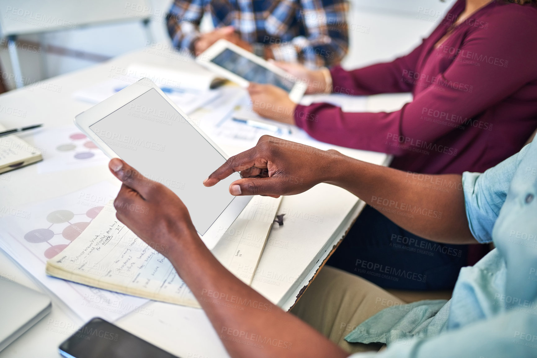 Buy stock photo Closeup shot of unidentifiable businesspeople working on digital tablets in an office