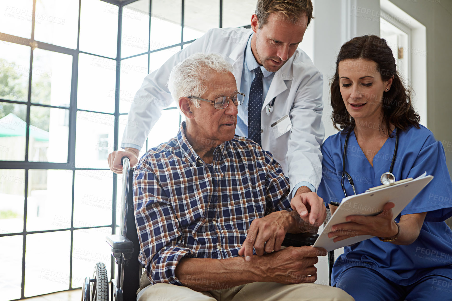 Buy stock photo Cropped shot of a senior man in the retirement home with his doctor and nurse