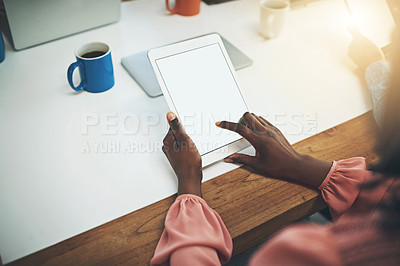Buy stock photo Shot of an unrecognisable businesswoman using a digital tablet in an office