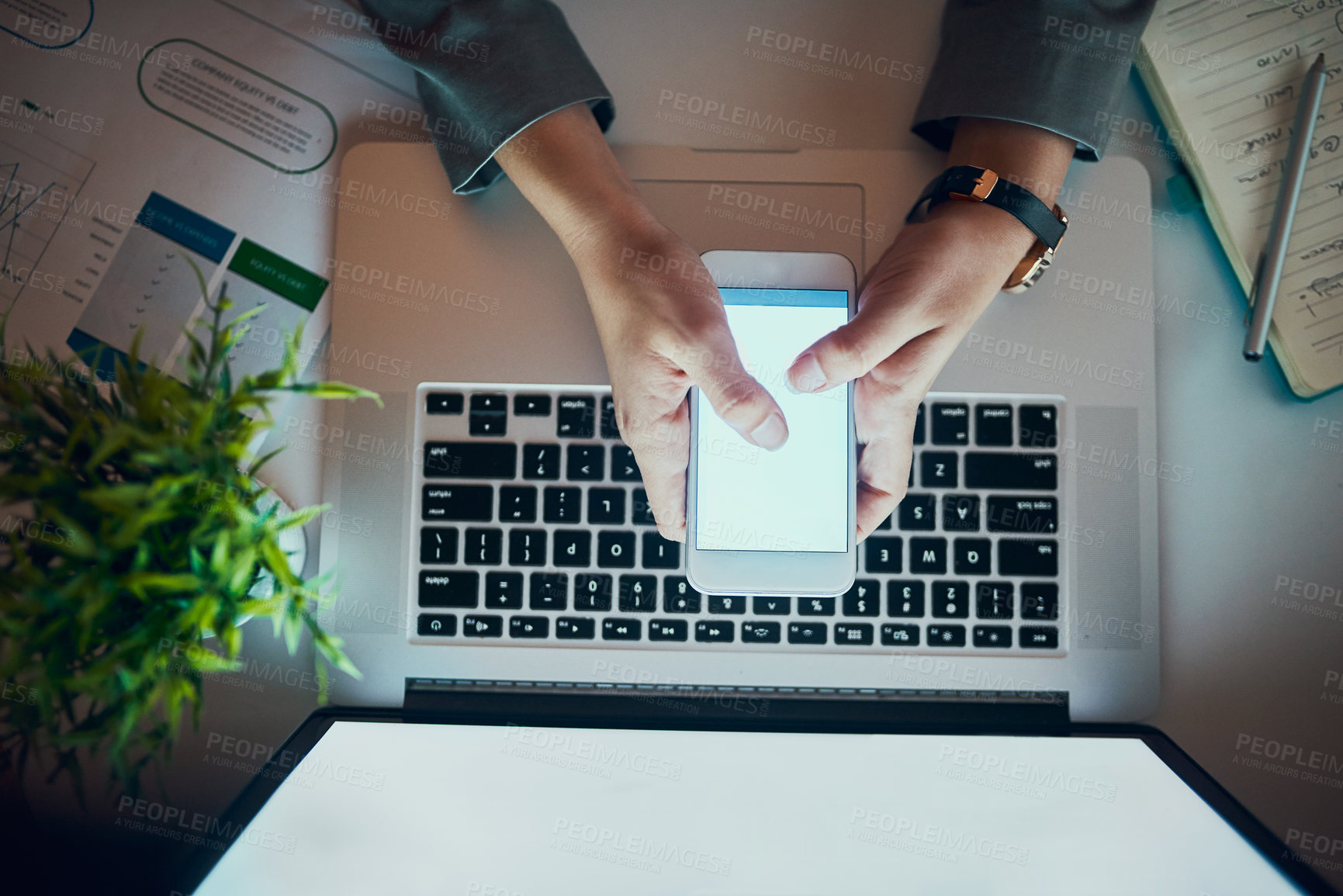 Buy stock photo High angle shot of an unrecognizable woman using a cellphone in the office