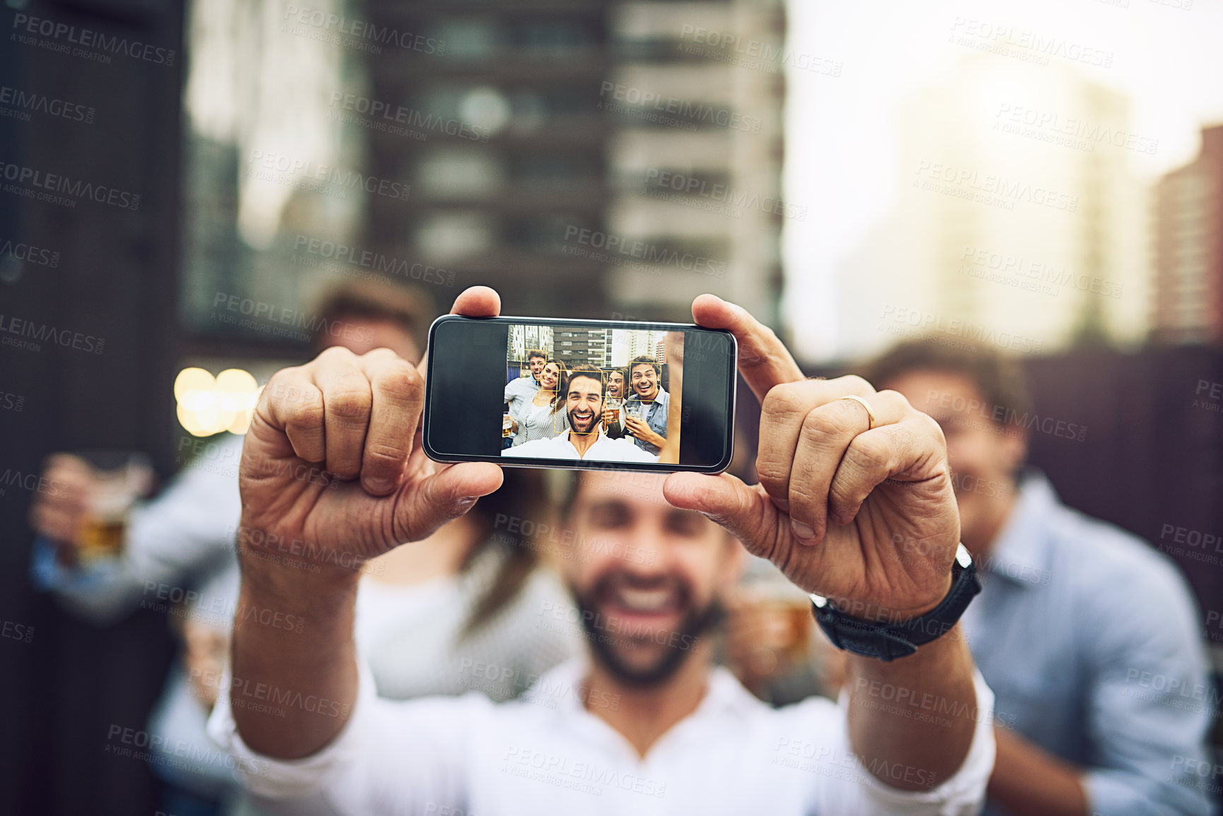 Buy stock photo Portrait of a group of cheerful young work colleagues taking a self portrait together outside during the day