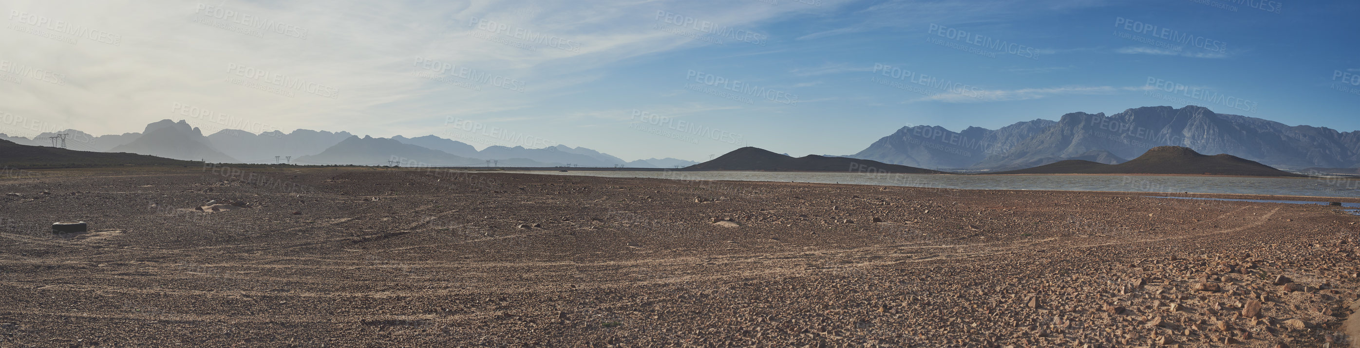 Buy stock photo Shot of a desolate landscape during the day with a small dried out dam in the middle with the words 