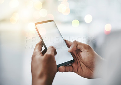 Buy stock photo Studio shot of an unrecognizable young man using his cellphone against a grey background