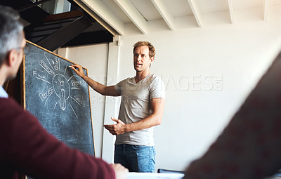 Buy stock photo Shot of a creative business team having a meeting and discussing business related issues in the office