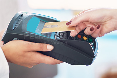 Buy stock photo Cropped shot of a customer using her credit card to make a payment