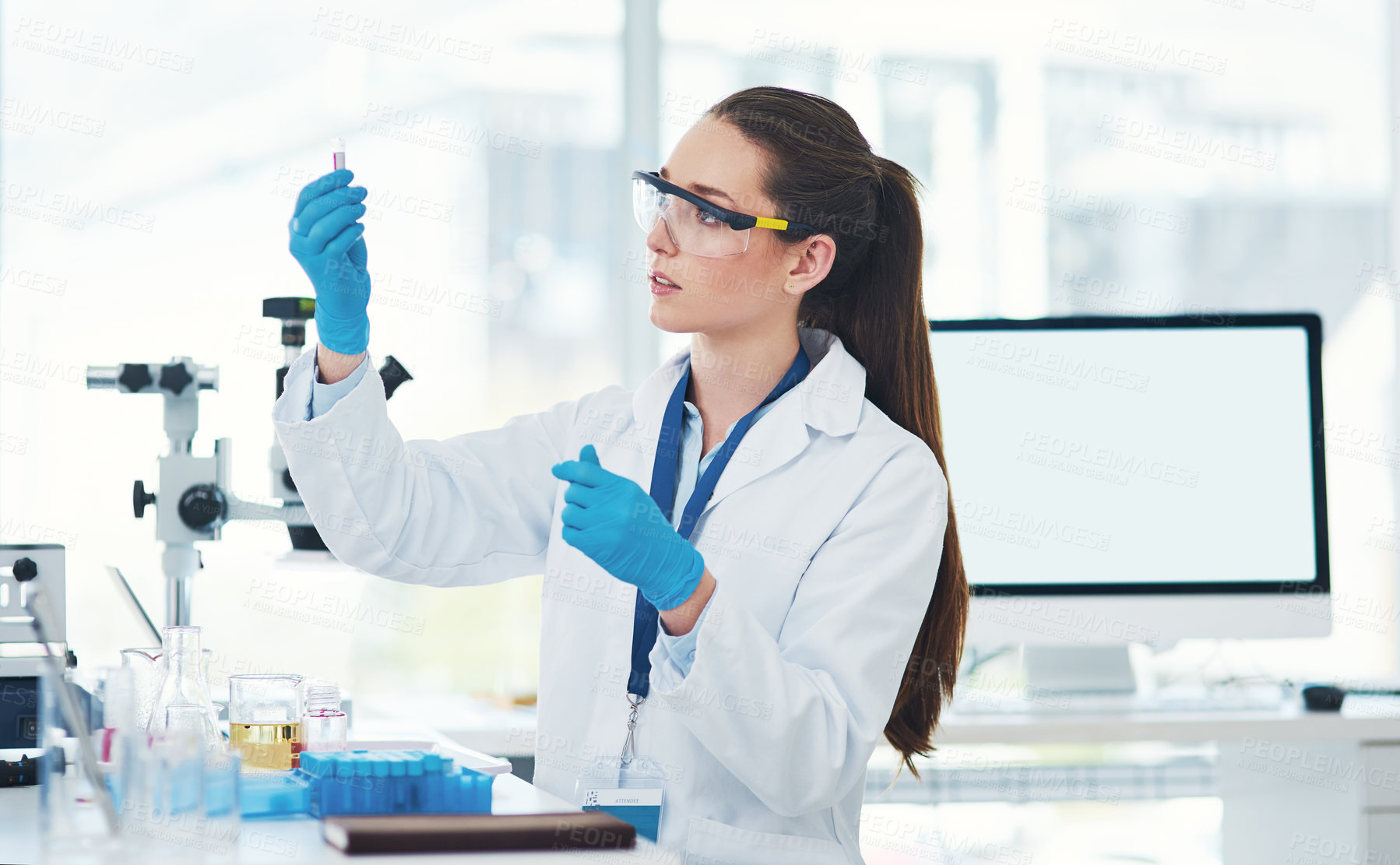 Buy stock photo Cropped shot of a focused young female scientist mixing chemicals together inside of a laboratory during the day