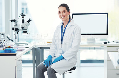 Buy stock photo Portrait of a cheerful young female scientist seated at her desk ready to work inside of a laboratory during the day