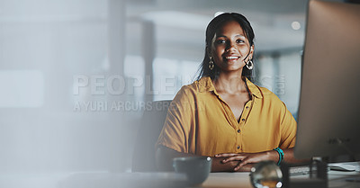 Buy stock photo Portrait of a young businesswoman working on a computer in an office at night