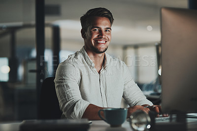 Buy stock photo Portrait of a young businessman working on a computer in an office at night