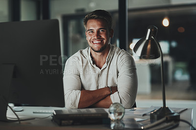 Buy stock photo Portrait of a young businessman working on a computer in an office at night