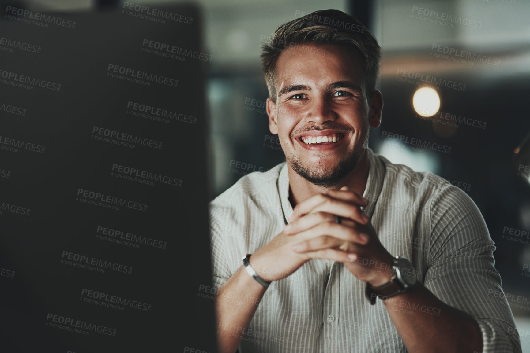 Buy stock photo Portrait of a young businessman working on a computer in an office at night