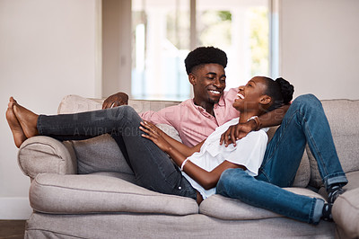 Buy stock photo Shot of a happy young couple relaxing on the sofa at home