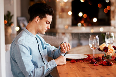 Buy stock photo Date, watch and man waiting while in the restaurant for valentines day checking the time. Fine dining, late and upset guy by the table for a dinner reservation for anniversary or romantic event.