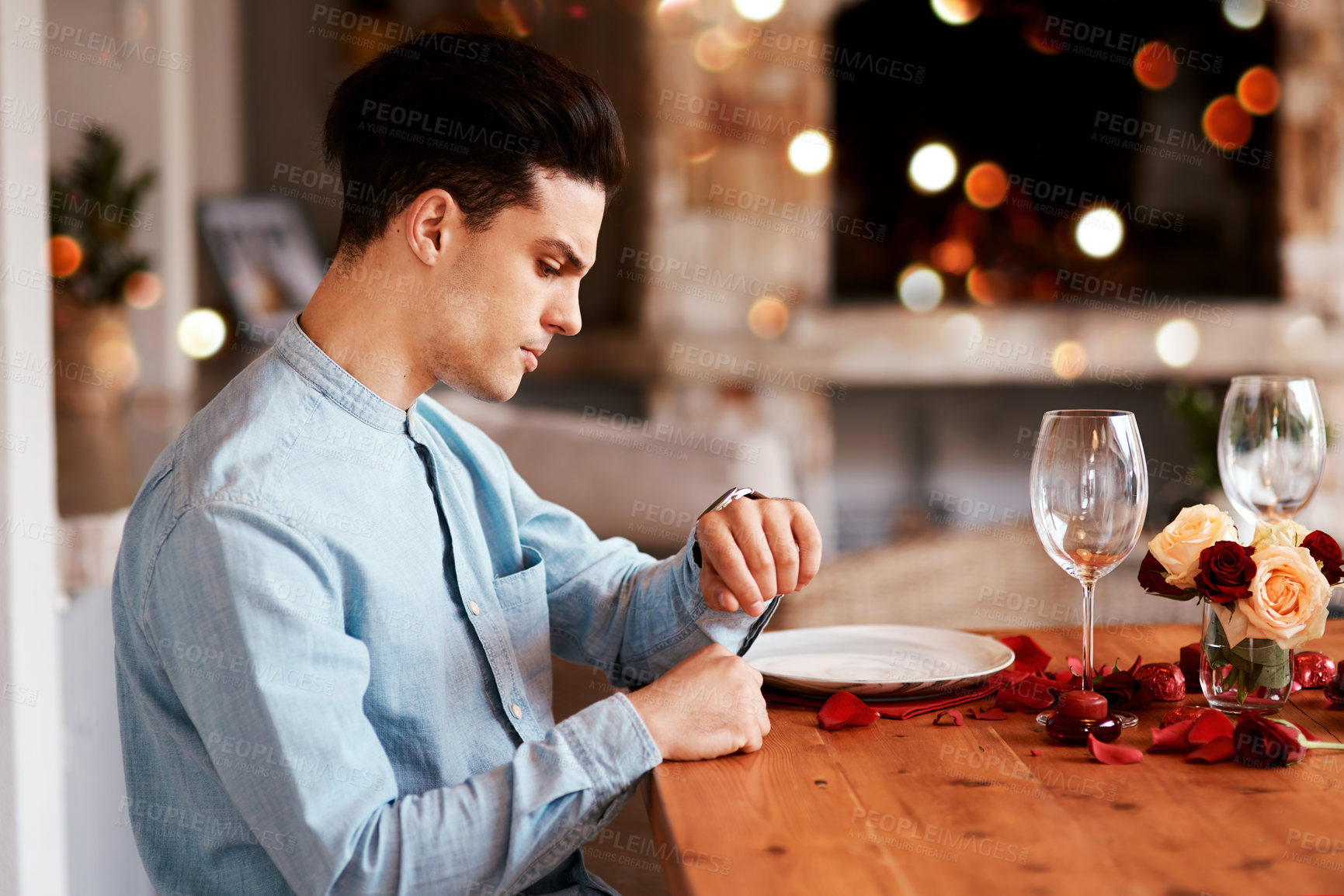 Buy stock photo Date, watch and man waiting while in the restaurant for valentines day checking the time. Fine dining, late and upset guy by the table for a dinner reservation for anniversary or romantic event.