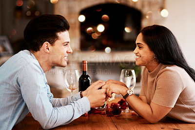 Buy stock photo Love, romance and couple holding hands at table on valentines day date at home with smile and bokeh. Date night, man and woman in living room, valentine celebration and happy relationship together.