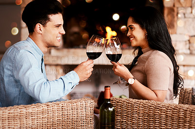 Buy stock photo Love, wine and couple cheers at fireplace on valentines day date at home with smile and bokeh. Date night, man and woman embrace in living room, valentine celebration and happy relationship together.
