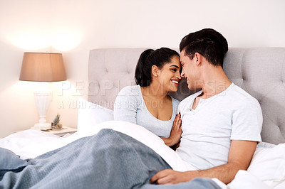 Buy stock photo Bed, happy love and interracial couple together in home holding hands at night. Smile diversity and marriage of an Indian woman and man with care and relax happiness with a smile in a house bedroom