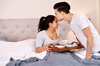 Buy stock photo Breakfast in bed, food and couple at home together with a kiss, care and love in a house. Valentines day, relax and smile of an Indian woman and man in the morning in bedroom with tray and happiness 
