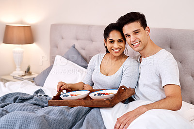 Buy stock photo Portrait, breakfast in bed and valentines day with a couple in their home together in the morning. Food, birthday or bedroom with a young man and woman bonding in their house to relax for romance