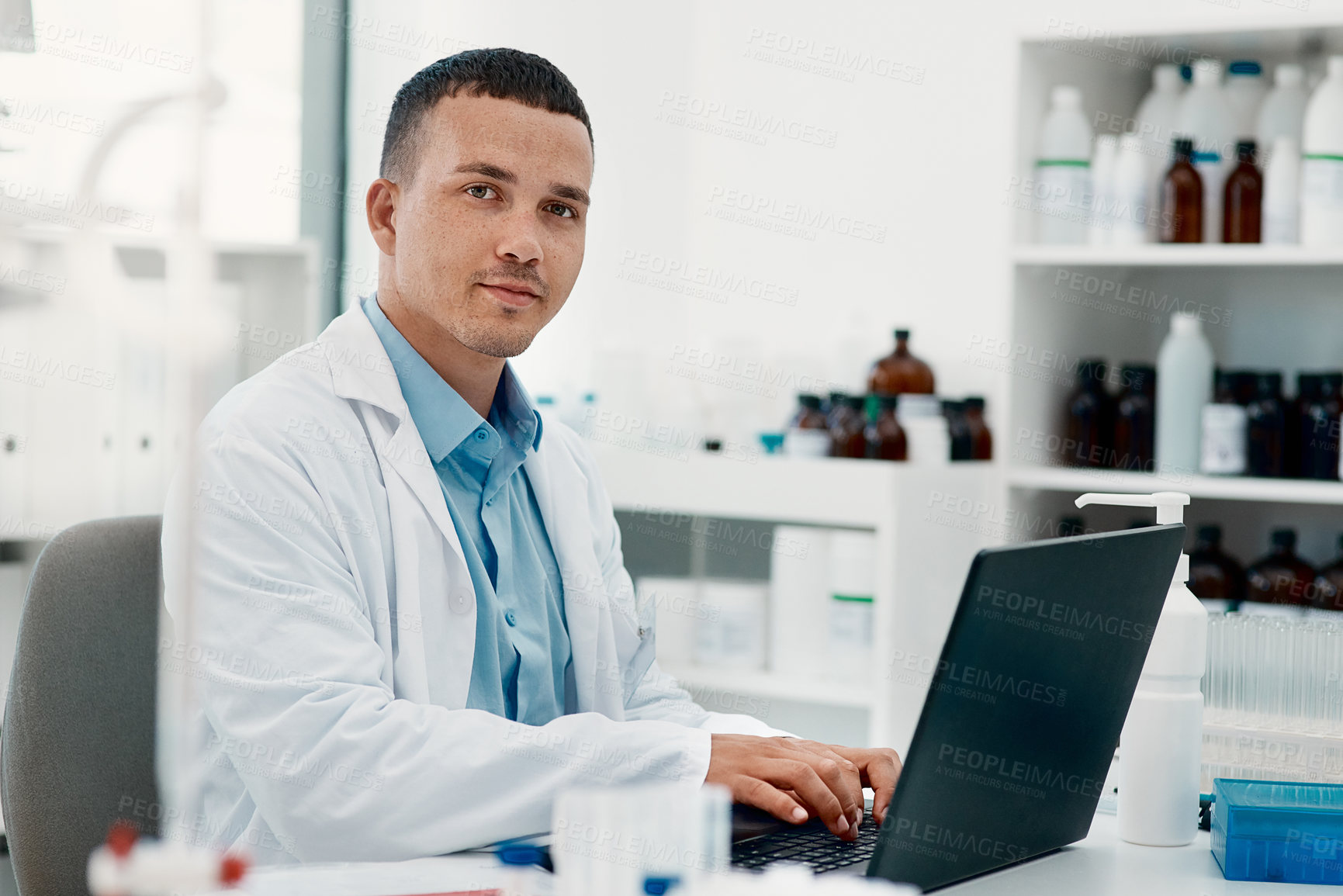 Buy stock photo Portrait of a young scientist using a laptop while working in a laboratory