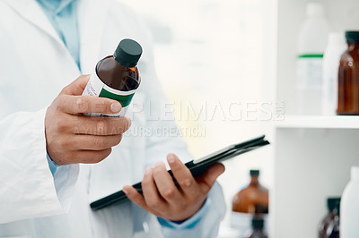 Buy stock photo Cropped of a scientist using a digital tablet while analysing medication in a laboratory