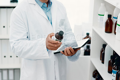 Buy stock photo Cropped of a scientist using a digital tablet while analysing medication in a laboratory