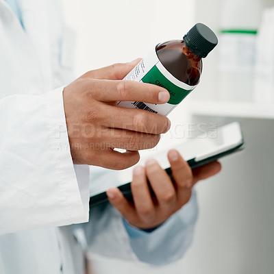 Buy stock photo Cropped of a scientist using a digital tablet while analysing medication in a laboratory