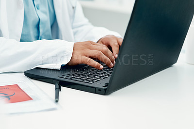 Buy stock photo Cropped shot of a scientist using a laptop while researching the coronavirus in a laboratory