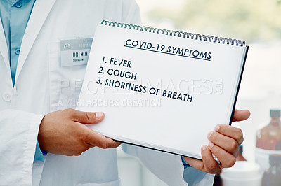 Buy stock photo Cropped shot of a scientist holding a sign with a list of COVID-19 symptoms on it in a modern laboratory