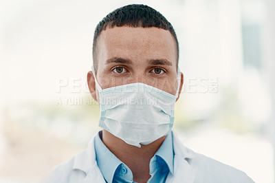 Buy stock photo Portrait of a confident young scientist wearing a mask in a modern laboratory