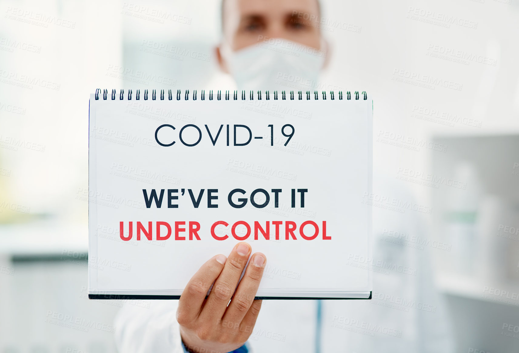 Buy stock photo Cropped shot of a scientist holding a sign with “We’ve got it under control” on it in a laboratory