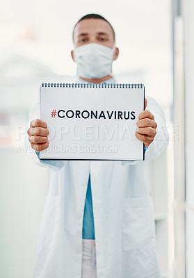 Buy stock photo Portrait of a young scientist holding a sign with “#CORONAVIRUS” on it in a modern laboratory