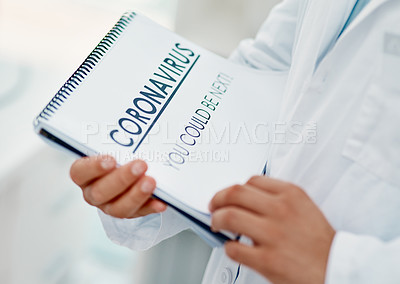 Buy stock photo Shot of a scientist holding a notepad with “CORONAVIRUS-YOU COULD BE NEXT” on it in a laboratory