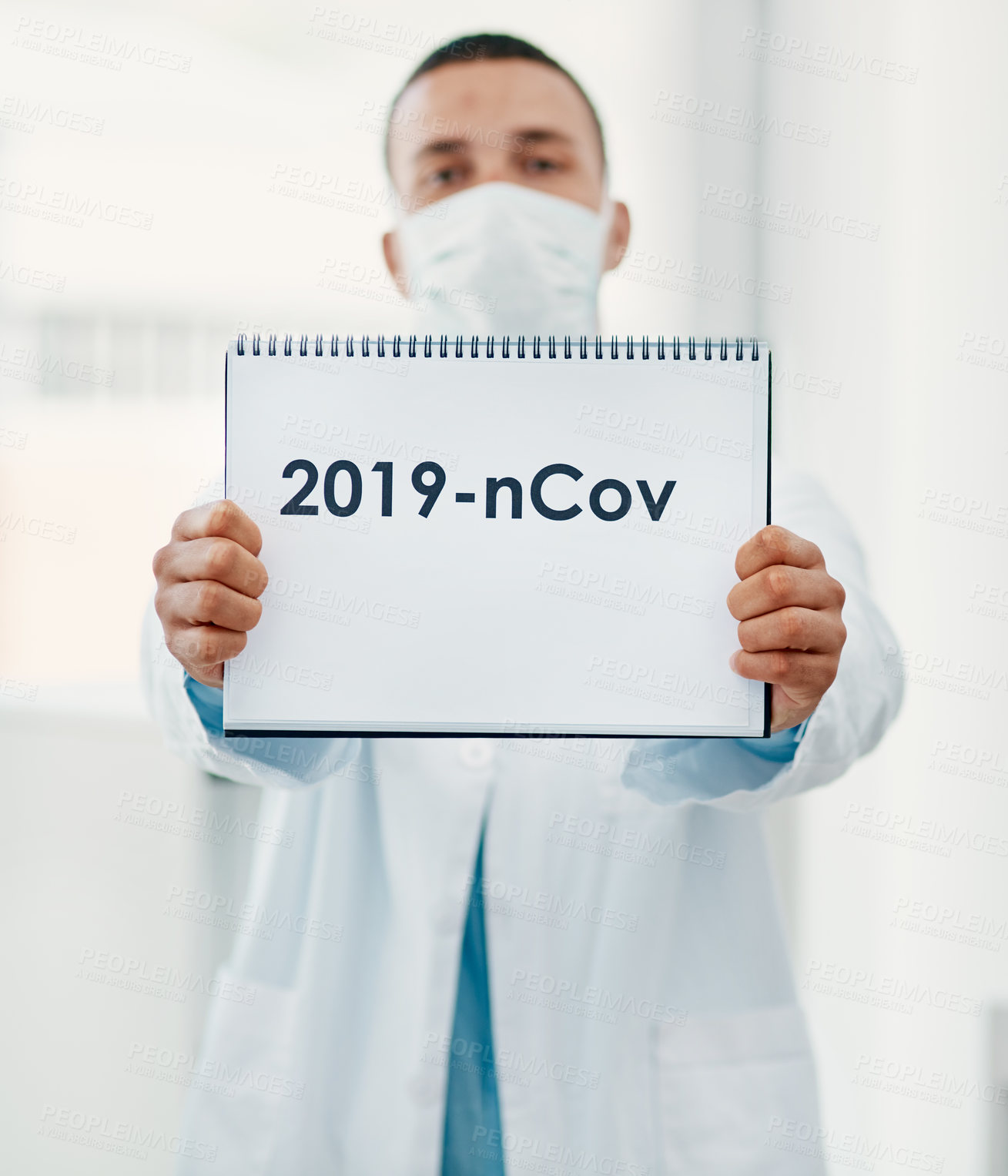 Buy stock photo Shot of a scientist holding a sign with “2019-nCov” on it in a modern laboratory