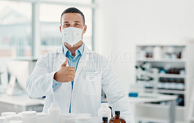 Buy stock photo Portrait of a confident young scientist showing thumbs up in a modern laboratory