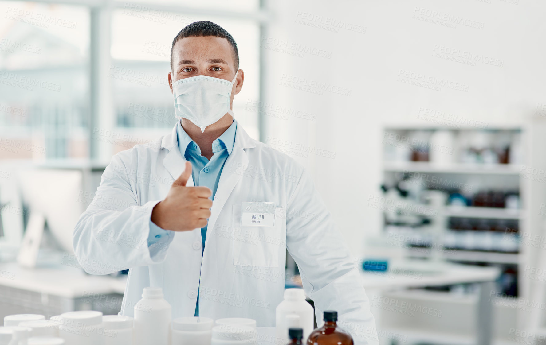 Buy stock photo Healthcare, man and thumbs up for medicine, chemist and gesture for approval, portrait and yes for antibiotics. Pharmacy, promotion and person with mask, pills and agreement with treatment in USA