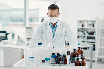 Buy stock photo Shot of a young scientist analysing medication in a laboratory