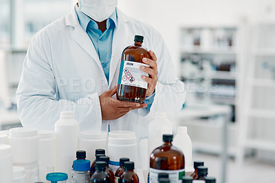 Buy stock photo Cropped shot of a scientist analysing medication in a laboratory